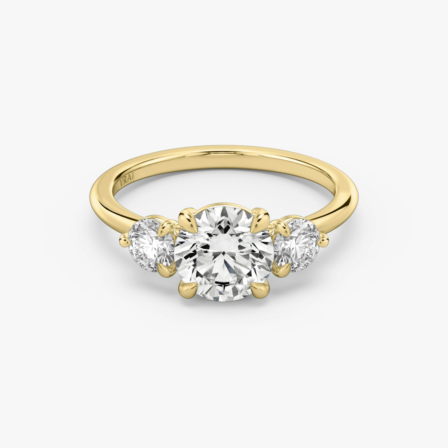 Jewelry Facebook ad example 49: The Three Stone Round Brilliant Engagement Ring | 18k Yellow Gold