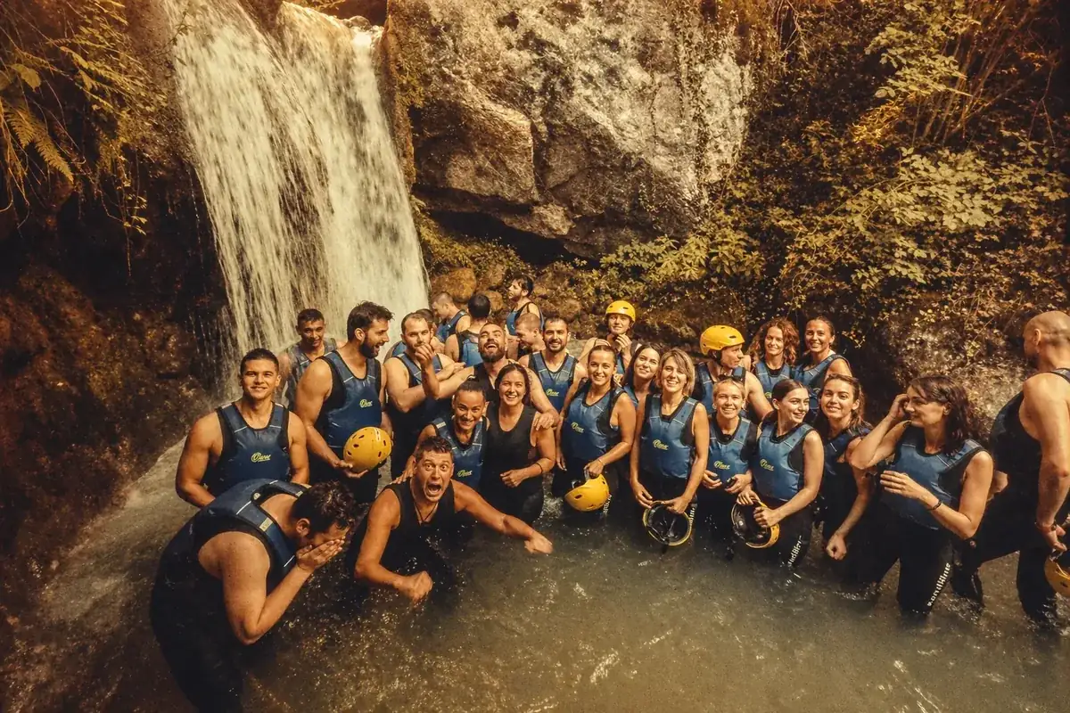 Coinis team at a waterfall, laughing together