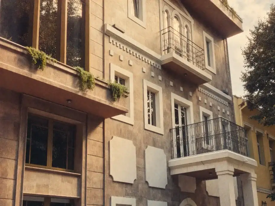 Ornate stone facade with wrought-iron balconies and window boxes at Coinis HQ