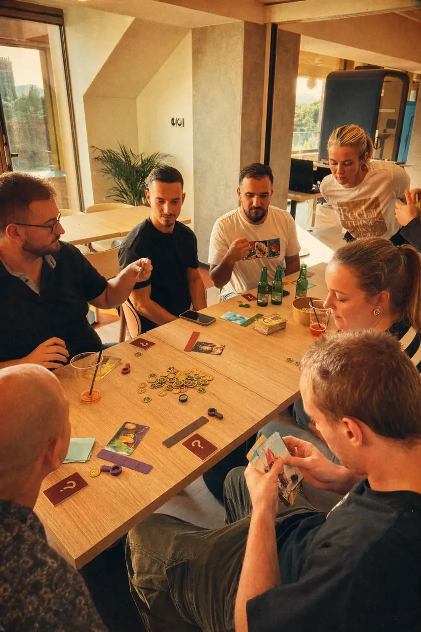 Coinis teammates playing a board game during casual office game night