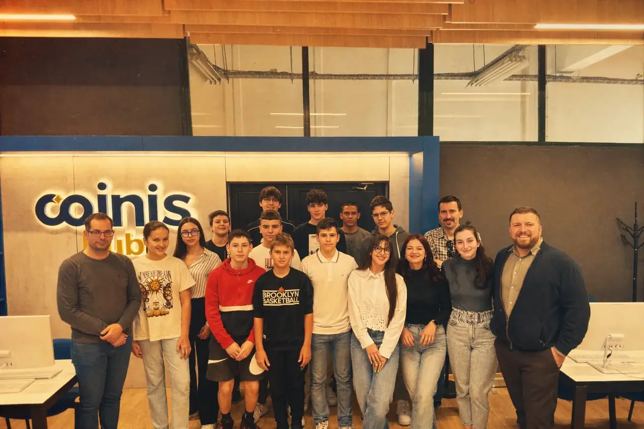 Coinis team posing for a group photo on the office floor