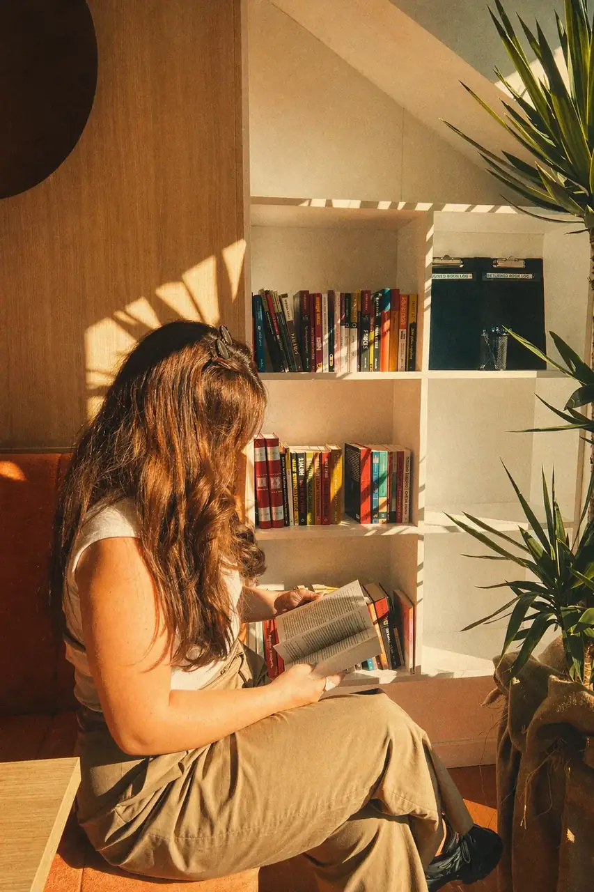 Coinis teammate reading a book in the office library corner