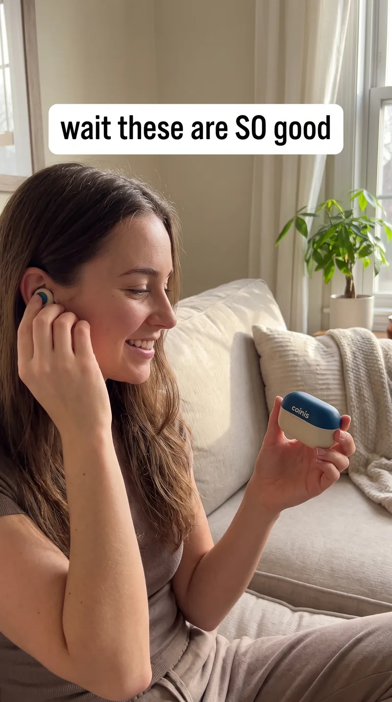 UGC photo of a woman using wireless earbuds on a couch