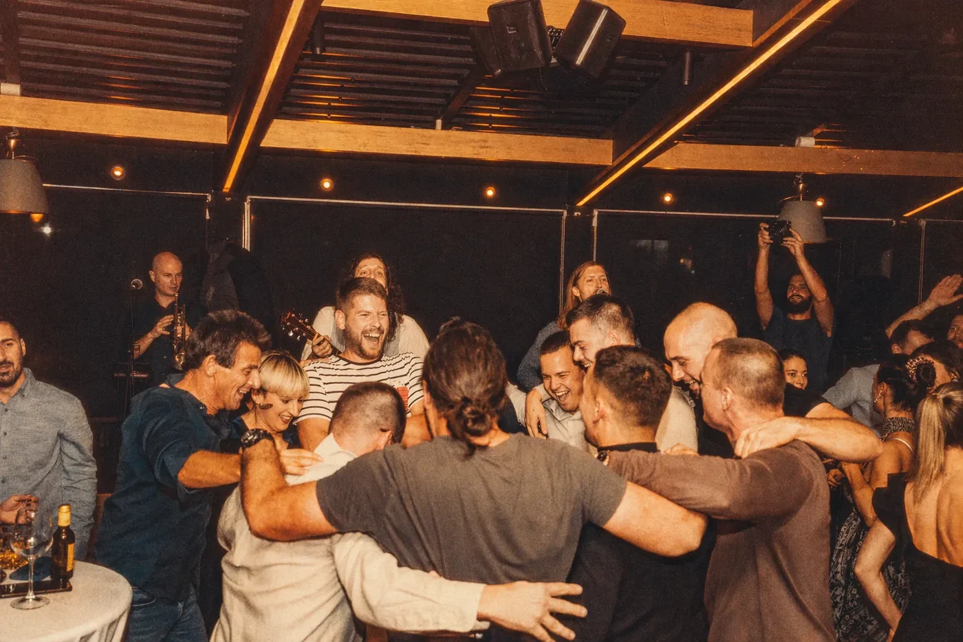 Coinis teammates celebrating in a circle with a group hug